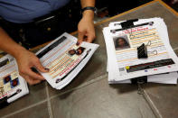 Washington Metropolitan Police Department Sergeant Jessica Hawkins, a transgender woman who leads the department's lesbian, gay, bisexual and transgender (LGBT) unit, displays information about unsolved murders of LGBT victims at her office in Washington, U.S. October 10, 2016. REUTERS/Jonathan Ernst