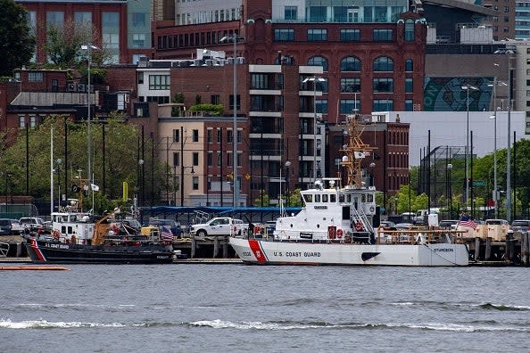 Two US Coast Guard vessels sit in port in Boston Harbor across from the US Coast Guard Station Boston in Boston, Massachusetts, (AFP via Getty Images)