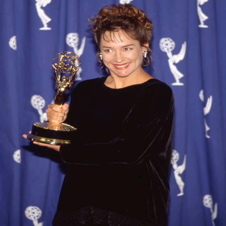 Close-up of Laurie holding an award