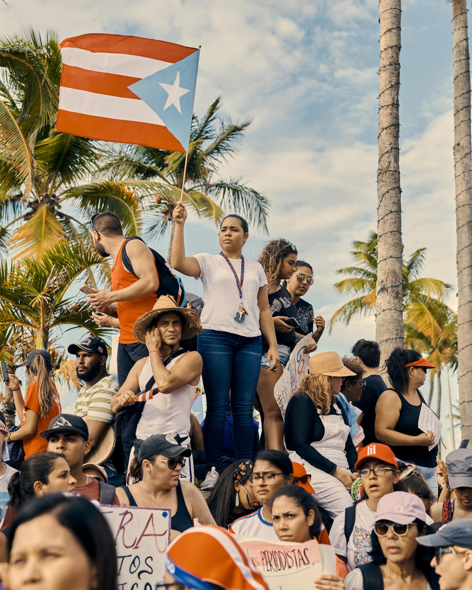 A woman waves a Puerto Rican flag at the anti-Rosselló protest in San Juan, Puerto Rico, on July 17, 2019. | Christopher Gregory for TIME