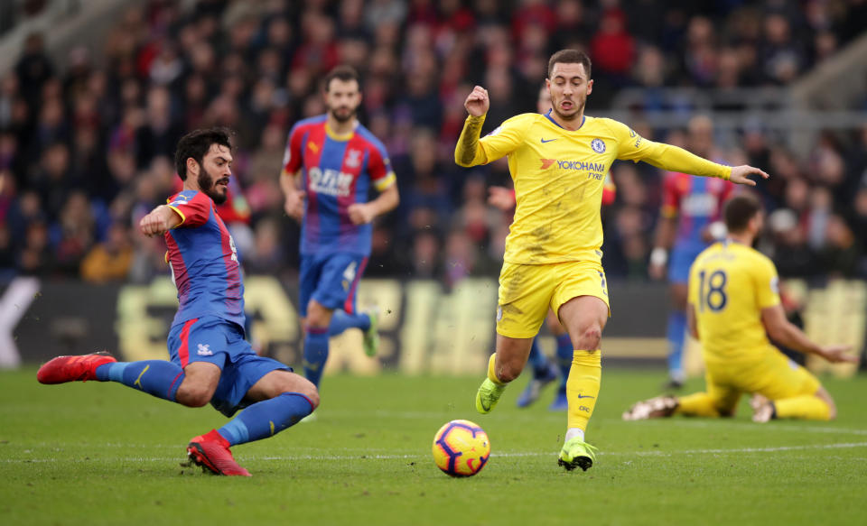 Chelsea’s Eden Hazard is challenged by Crystal Palace’s James Tomkins (left)