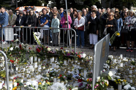 People attend a moment of silence to commemorate the victims of Friday's stabbings at the Turku Market Square in Turku, Finland August 20, 2017. Lehtikuva/Vesa Moilanen via REUTERS
