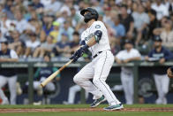 Seattle Mariners' Mitch Haniger watches his solo home run off a pitch by New York Yankees' Jameson Taillon during the first inning of a baseball game, Monday, Aug. 8, 2022, in Seattle. (AP Photo/John Froschauer)