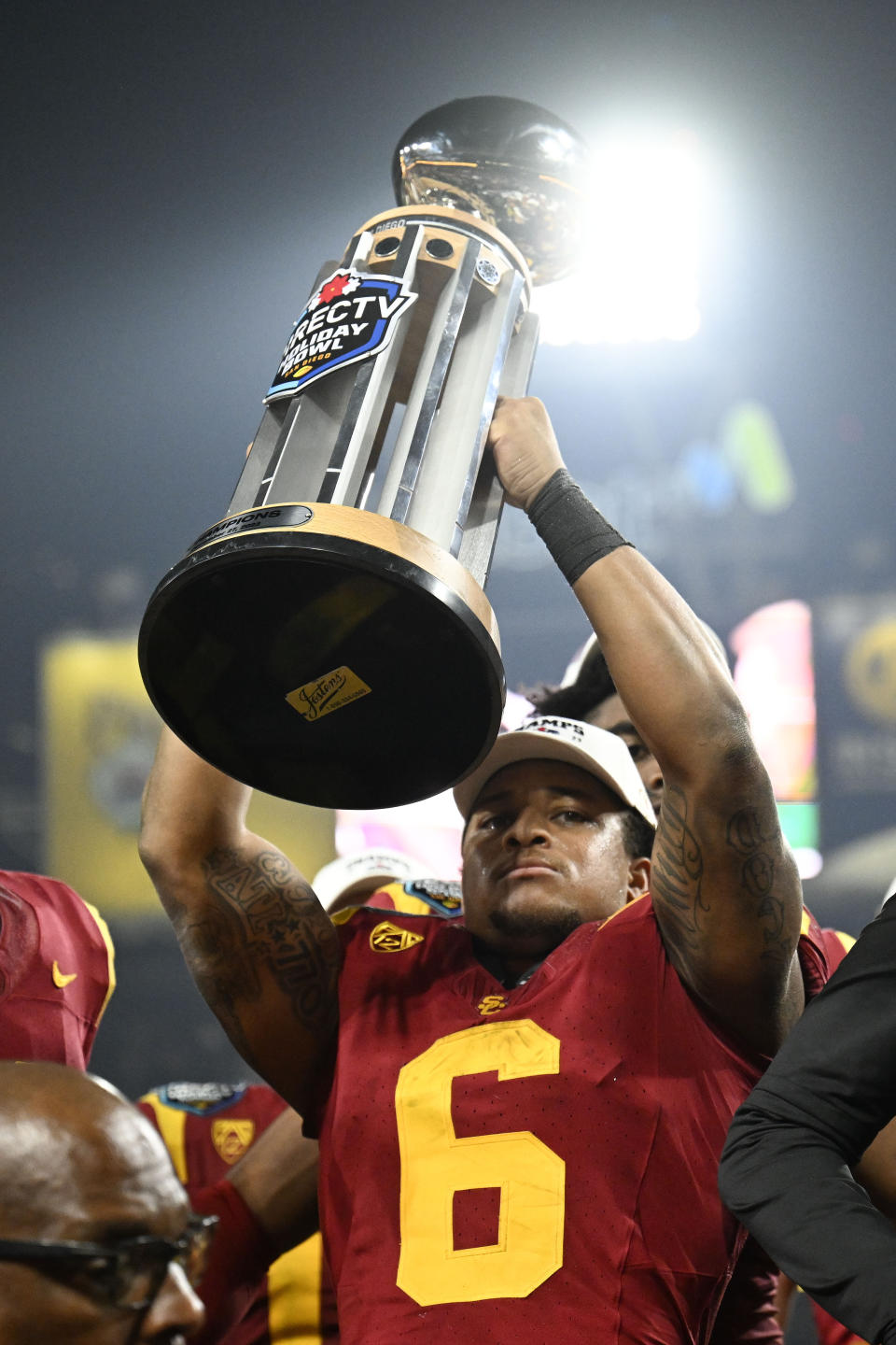 Southern California running back Austin Jones hoists the trophy after the team's win over Louisville in the Holiday Bowl NCAA college football game Wednesday, Dec. 27, 2023, in San Diego. (AP Photo/Denis Poroy)