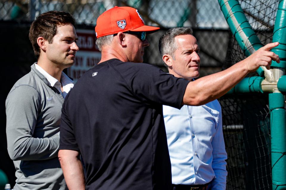 Detroit Tigers chairman and CEO Chris Ilitch and president of baseball operations Scott Harris talk to manager A.J. Hinch during spring training at TigerTown in Lakeland, Fla. on Tuesday, Feb. 20, 2024.