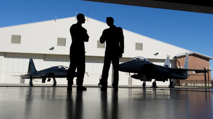 U.S. Air Force pilots inside a hangar alongside a F-15 fighter jet and a T-38 Talon trainer jet during an exercise in 2015. (Saul Loeb/AFP via Getty Images)
