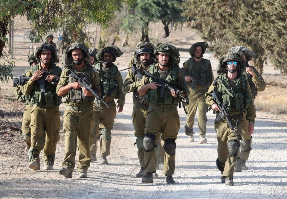 Israeli troops patrol at an undisclosed location along the Gaza border (AFP via Getty Images)