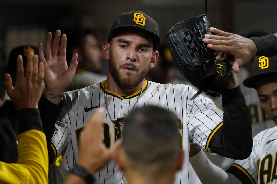 San Diego Padres starting pitcher Joe Musgrove, center, reacts with teammates in the dugout after exiting during the sixth inning of the team's baseball game against the Colorado Rockies, Friday, June 10, 2022, in San Diego. (AP Photo/Gregory Bull)