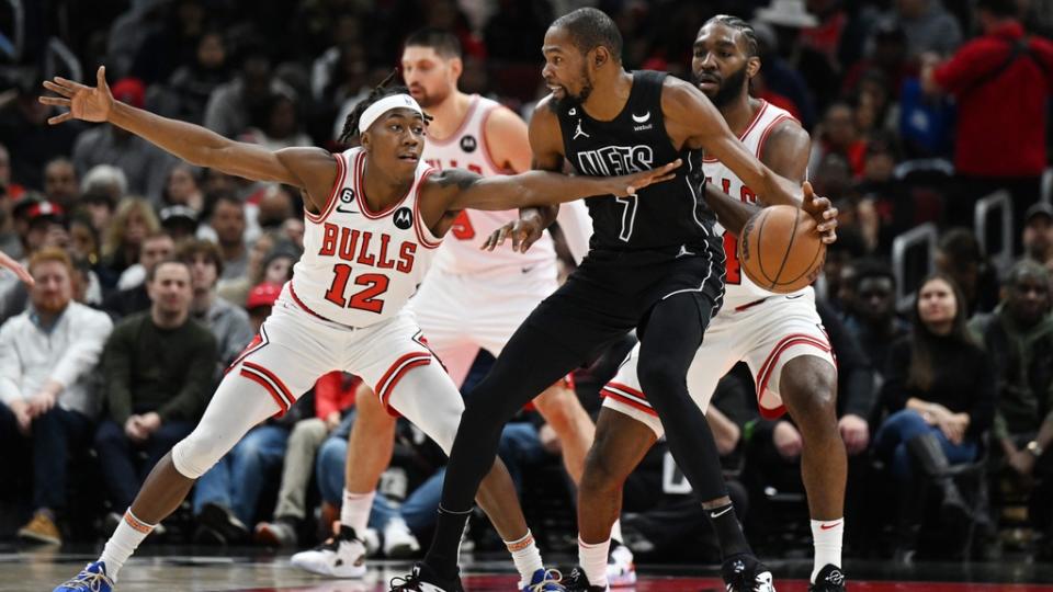 Jan 4, 2023; Chicago, Illinois, USA; Brooklyn Nets forward Kevin Durant (7) is defended in the first half by Chicago Bulls guard Ayo Dosunmu (12) and Patrick Williams (44) at United Center.