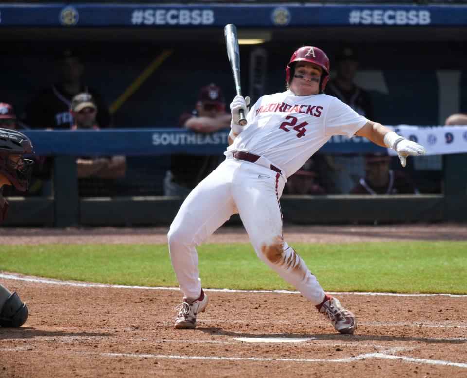 Arkansas batter Peyton Holt has to flex awkwardly to avoid a pitch thrown behind him by a Texas A&M pitcher during the second round of the SEC Baseball Tournament at the Hoover Met Wednesday, May 24, 2023.  