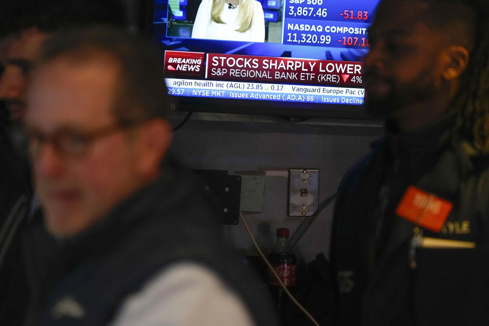 FILE - Traders work on the floor at the New York Stock Exchange in New York, March 15, 2023. Only 10% of U.S. adults say they have significant confidence in the nation’s banks and financial institutions, a new poll finds. That is down from the 22% who said they had high confidence in banks in 2020. The poll from the Associated Press-NORC Center for Public Affairs Research poll also finds that a majority of Americans say the government is not doing enough to regulate the industry. (AP Photo/Seth Wenig, File)