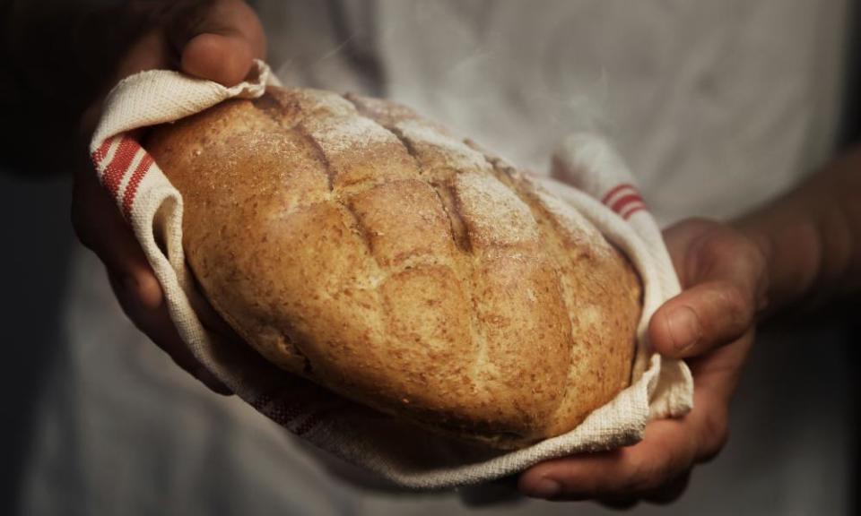 Male baker holding a loaf