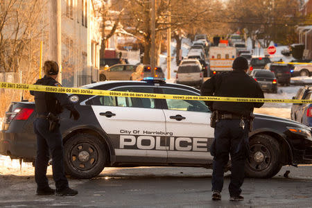 Police officers guard an intersection after officer-involved shooting in Harrisburg, Pennsylvania, U.S., January 18, 2018. REUTERS/Daniel Shanken