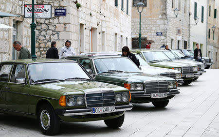 A woman looks at old-timer Mercedes cars in Imotski, Croatia, May 19, 2019. REUTERS/Antonio Bronic