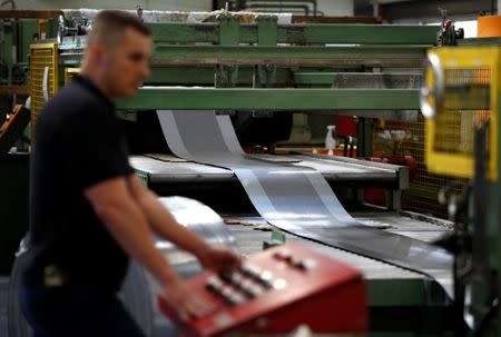 A worker at perforating company Bion uses a machine at the factory in Reading, Britain September 22, 2016. REUTERS/Peter Nicholls