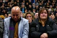 Mourners attend a memorial for the victims of a Ukrainian passenger plane which was shot down in Iran