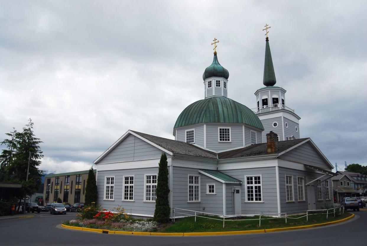 St. Michael's Russian Orthodox Cathedral against the typically overcast sky of the temperate rainforest in Sitka, Alaska, USA. Originally completed in 1848 and rebuilt to original blueprints after a 1966 fire. St. Micheal's is the mother church for 88 par