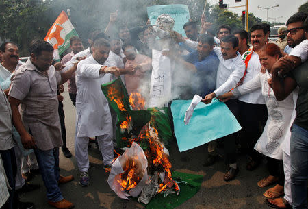 Protesters burn an effigy depicting "terrorism" along with the national flag of Pakistan during a protest against Sunday’s attack at an Indian army base in Kashmir's Uri, in Chandigarh, India, September 19, 2016. REUTERS/Ajay Verma