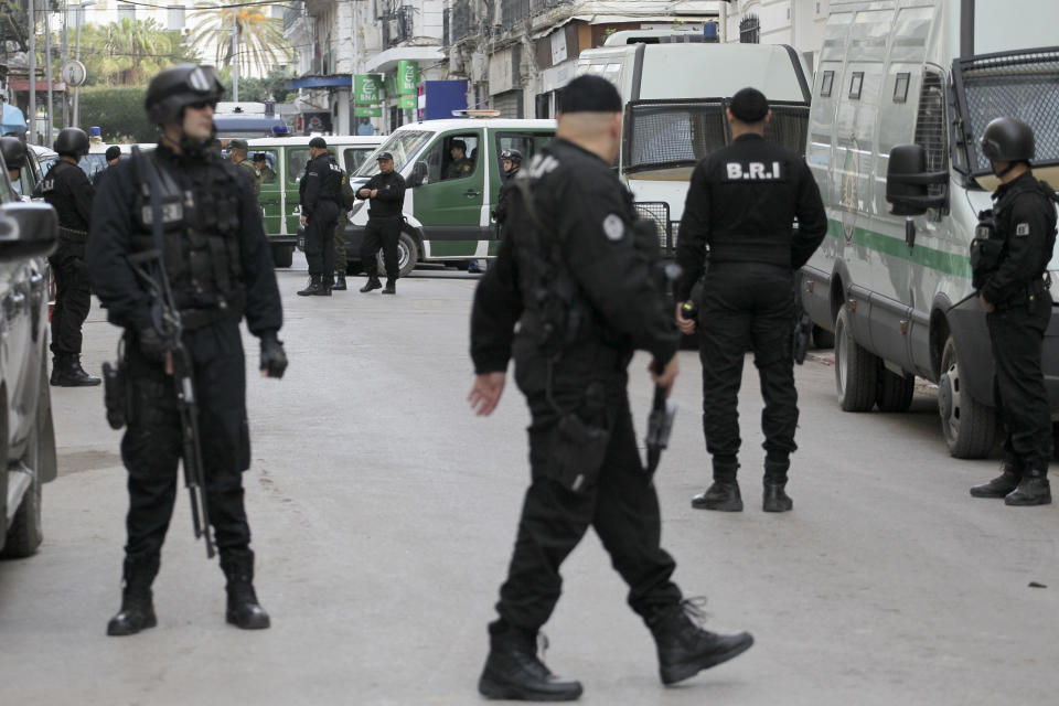 Algerian security forces guard the courtroom as former Algerian Prime Ministers Ahmed Ouyahia and Abdelmalek Sellal face corruption charges, Wednesday, Dec.4, 2019 in Algiers. Ahmed Ouyahia, who was forced out as prime minister in March as protests against President Abdelaziz Bouteflika escalated, and his predecessor Abdelmalek Sellal, are facing questions Wednesday at the Sidi M'Hamed court in Algiers. (AP Photo/Toufik Doudou)