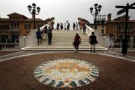 A Venetian Lion emblem adorns the footpath as pedestrians walk across a bridge over a canal that flows through the center of the Florentia Village in the district of Wuqing, located on the outskirts of the city of Tianjin June 13, 2012. <br><br><a href="http://news.yahoo.com/photos/china-replicates-austrian-village-slideshow/" data-ylk="slk:Click here;elm:context_link;itc:0;sec:content-canvas;outcm:mb_qualified_link;_E:mb_qualified_link;ct:story;" class="link  yahoo-link">Click here</a> to see a related gallery: China replicates Austrian village