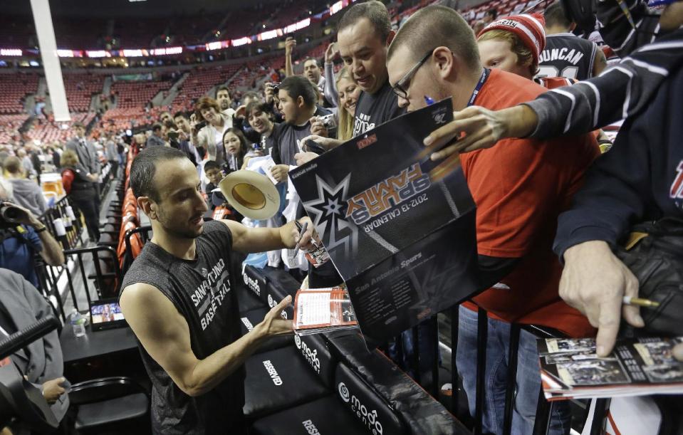 San Antonio Spurs' Manu Ginobili (20) signs autographs after practice before the start of their Game 3 of a Western Conference semifinal NBA basketball playoff series against the Portland Trail Blazers, Saturday, May 10, 2014, in Portland, Ore. (AP Photo/Rick Bowmer)