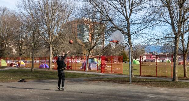 A newly installed fence is pictured enclosed around temporary homeless shelters at Strathcona Park in Vancouver, British Columbia on Friday, February 12, 2021. 