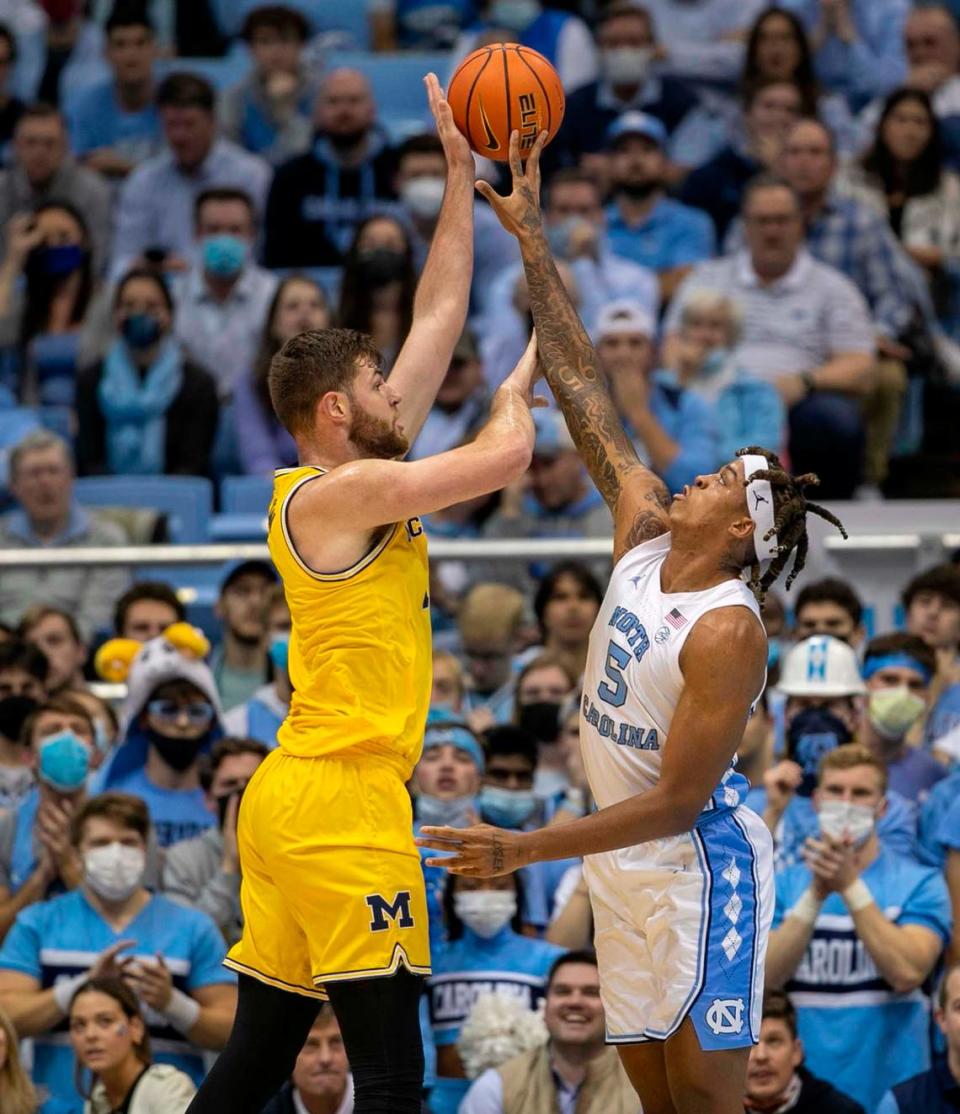 North Carolina’s Armando Bacot (5) defends Michigan’s Hunter Dickinson (1) during the first half on Wednesday, December 1, 2021 at the Smith Center in Chapel Hill, N.C.