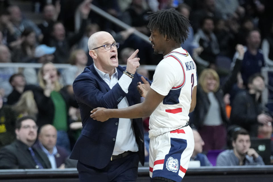 Connecticut head coach Dan Hurley congratulates Tristen Newton (2) after Newton scores three points in the first half of a second-round college basketball game against St. Mary's in the NCAA Tournament, Sunday, March 19, 2023, in Albany, N.Y. (AP Photo/John Minchillo)