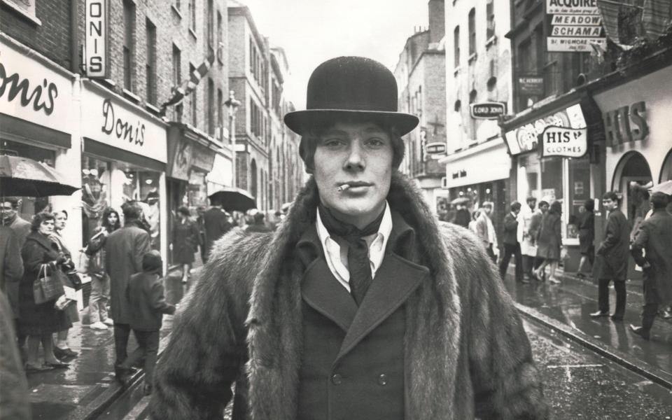 UNITED KINGDOM : Fashionable male wearing a bowler hat and fur coat standing in the middle of the road on Carnaby Street in London in the heart of the ?Swinging Sixties?. (Photo by SSPL/Getty Images)  - Getty