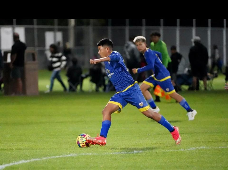 Venture Academy's Angelnoe Perez runs with the soccer ball during one of his club soccer games from the 2023-24 season.