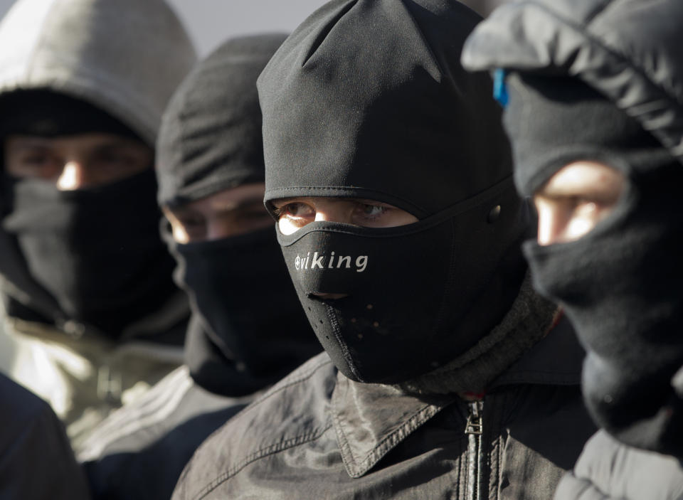 Members of the radical group Pravy Sektor (Right Sector) listen to their instructor as they practice street fighting in central Kiev, Ukraine, Monday, Feb. 3, 2014. Ukraine's president will return Monday from a short sick leave that had sparked a guessing game he was taking himself out of action in preparation to step down or for a crackdown on widespread anti-government protests. (AP Photo/Darko Bandic)