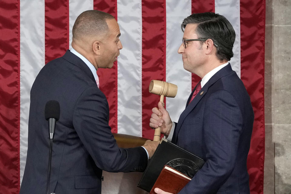 FILE - House Minority Leader Hakeem Jeffries of N.Y., hands the gavel to speaker-elect Rep. Mike Johnson, R-La., at the Capitol in Washington, Oct. 25, 2023. (AP Photo/Alex Brandon, File)