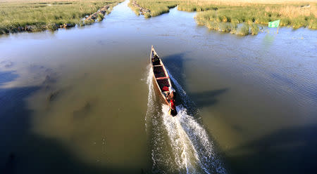 An Iraqi Marsh Arab man rides a boat at the Chebayesh marsh in Dhi Qar province, Iraq April 14, 2019. REUTERS/Thaier al-Sudani