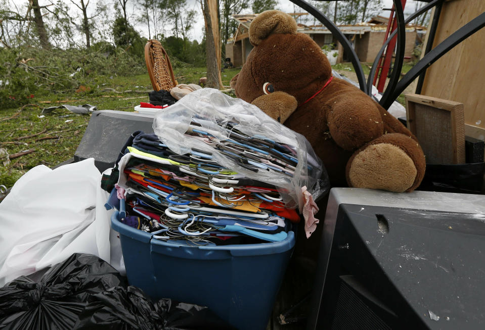 A Morton, Miss., resident loads all salvageable items on a trailer for removal from her storm damaged house, Friday, April 19, 2019. Strong storms again roared across the South on Thursday, topping trees and leaving a variety of damage in Mississippi, Louisiana and Texas. (AP Photo/Rogelio V. Solis)