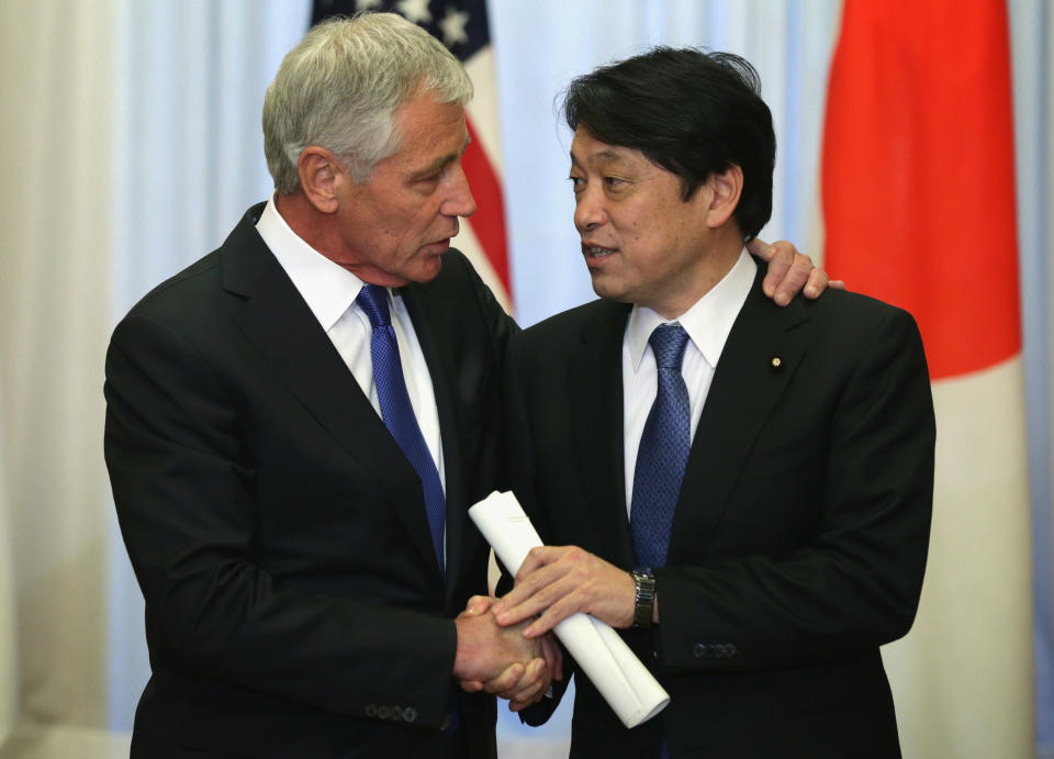 U.S. Secretary of Defense Chuck Hagel, left, shakes hands with Japanese Defense Minister Itsunori Onodera prior to a meeting with Japanese Prime Minister Shinzo Abe Saturday, April 5, 2014 at the prime minister's official residence, also known as Sori Daijin Kantei, in Tokyo, Japan. Hagel is on an Asian trip, the fourth time since he took office, to Japan, China and Mongolia. (AP Photo/Alex Wong, Pool)