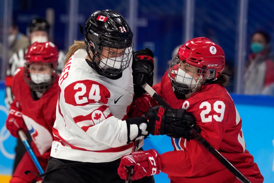 Canada&#39;s Natalie Spooner and the Russian Olympic Committee&#39;s Alexandra Vafina battle during Monday&#39;s game.