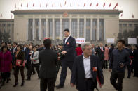 FILE - In this March 14, 2018, file photo, former NBA basketball player Yao Ming, center, a delegate to the Chinese People's Political Consultative Conference (CPPCC), leaves after a plenary session of the CPPCC at the Great Hall of the People in Beijing. Yao is now president of the Chinese Basketball Association, which announced over the weekend it is suspending its ties with the Rockets in retaliation for Houston Rockets general manager Daryl Morey's tweet that showed support for Hong Kong anti-government protesters. (AP Photo/Mark Schiefelbein, File)