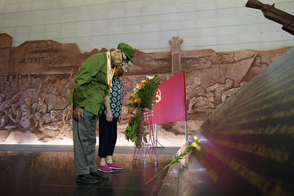 In this photo released by China's Xinhua News Agency, World War II veteran Xi Shurong, front, pays his respects during an event in commemoration of the 75th anniversary of the end of World War II in Nanchang in eastern China's Jiangxi Province, Thursday, Sept. 3, 2020. China is commemorating the 75th anniversary of the end of World War II in the Pacific, during which it endured a brutal invasion and occupation of much of its territory by Japan. (Zhou Mi/Xinhua via AP)