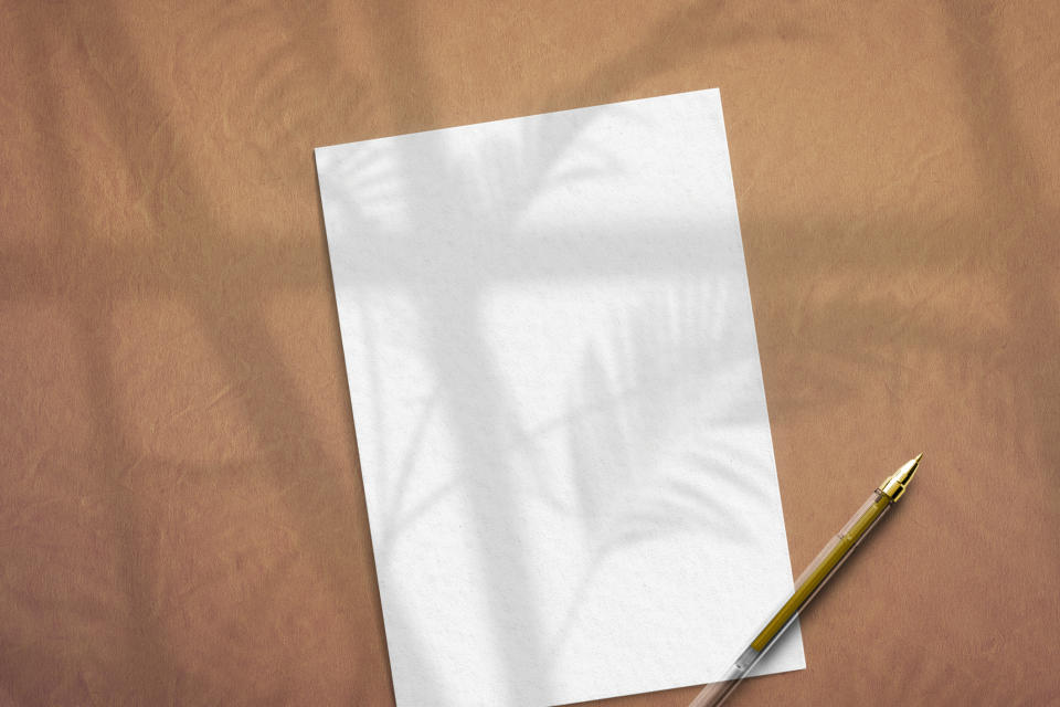 a blank paper with a pen on top of it