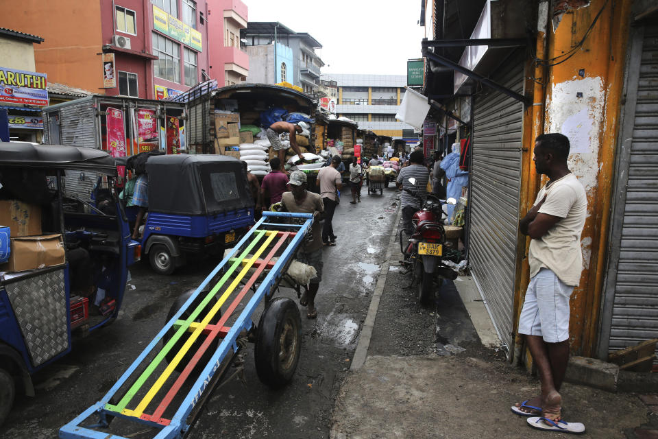 A Sri Lankan worker pushes his hand cart as he leaves after delivering goods in a whole sale market in Colombo, Sri Lanka, Tuesday, April 30, 2019. Sri Lanka is limping back to normalcy after the devastating bomb attacks on Easter Sunday that killed more than 250 people and wounded hundreds more. People and vehicles are slowly coming back on the road and shops are open but traders say that their business remain drastically low. (AP Photo/Manish Swarup)