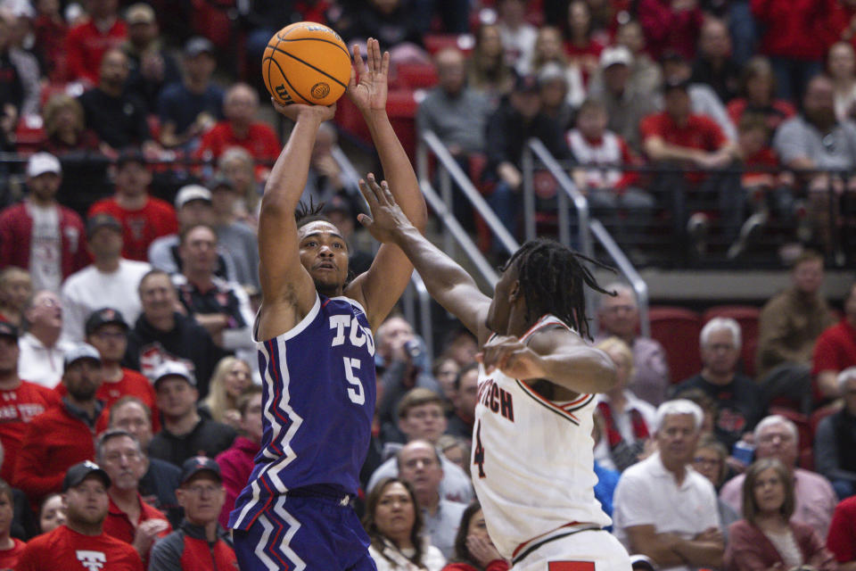 TCU's Chuck O'Bannon Jr. (5) shoots the over Texas Tech's Robert Jennings (4) during the second half of an NCAA college basketball game, Saturday, Feb. 25, 2023, in Lubbock, Texas. (AP Photo/Chase Seabolt)