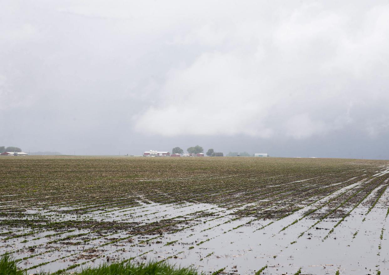 Water stands in a flooded field as a thunderstorm with rotation hangs over rural Dallas County on Tuesday, May 26, 2020.