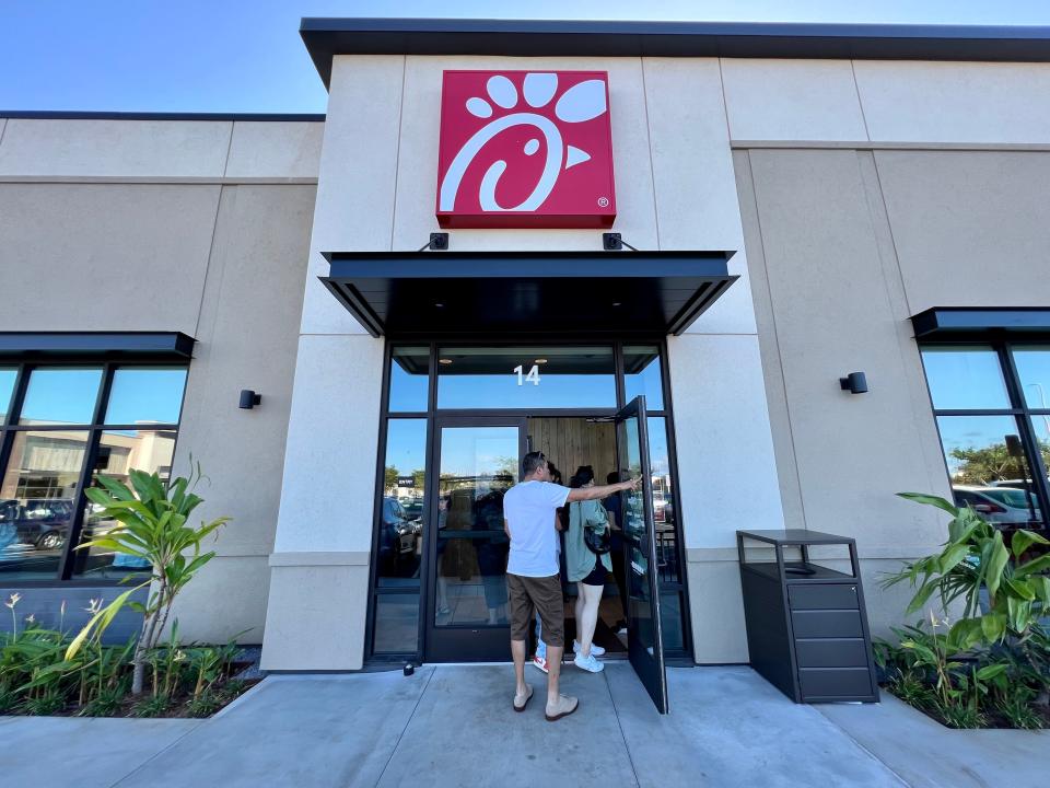 Customers entering a Chick-fil-A restaurant