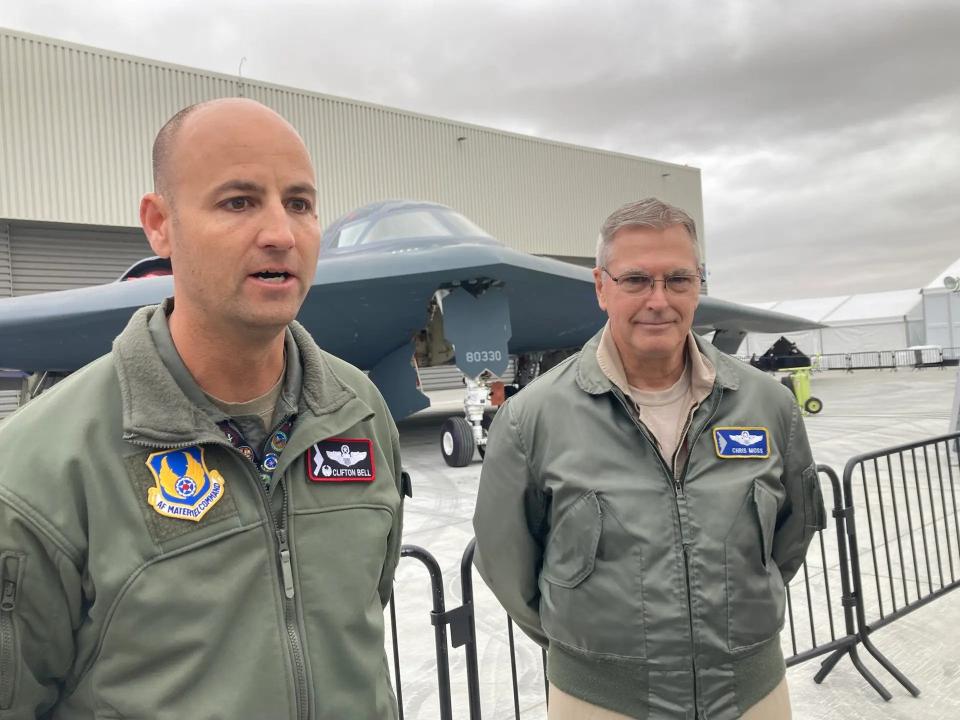 Air Force Lt. Col. Clifton Bell (l) and Northrop Grumman test pilot Chris Moss, talk to reporters at Northrop Grumman's Plant 42 in Palmdale, California, just hours before the public rollout of the Raider in December 2022. <em>Howard Altman, The War Zone photo</em>