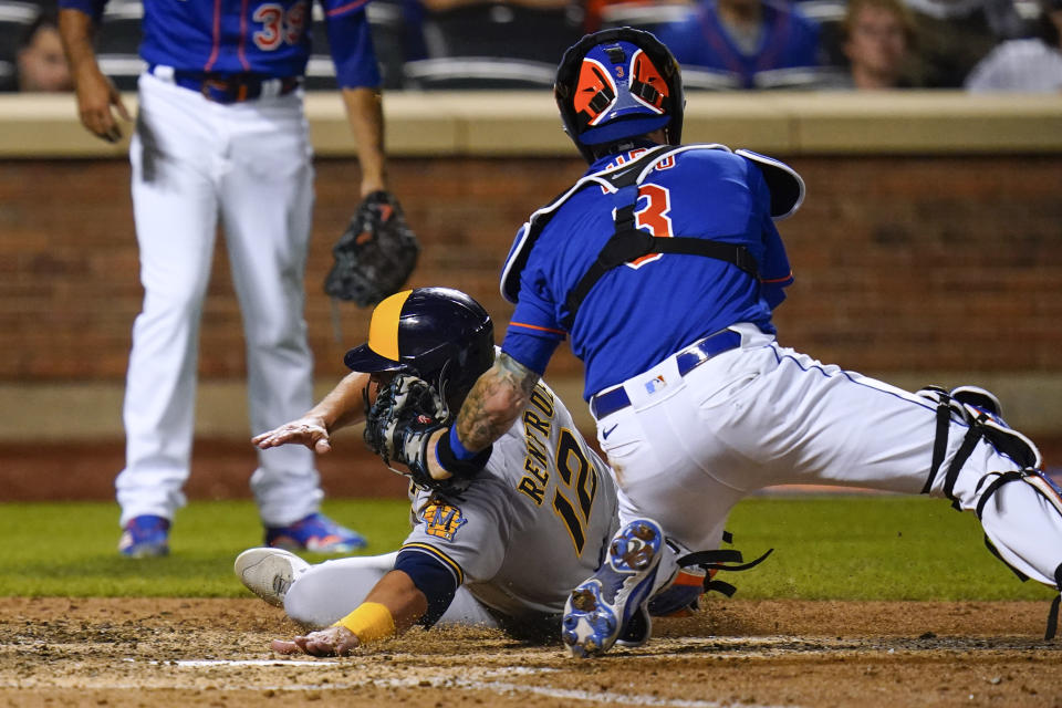 New York Mets catcher Tomas Nido (3) tags out Milwaukee Brewers' Hunter Renfroe during the ninth inning of a baseball game Thursday, June 16, 2022, in New York. The Mets won 5-4. (AP Photo/Frank Franklin II)