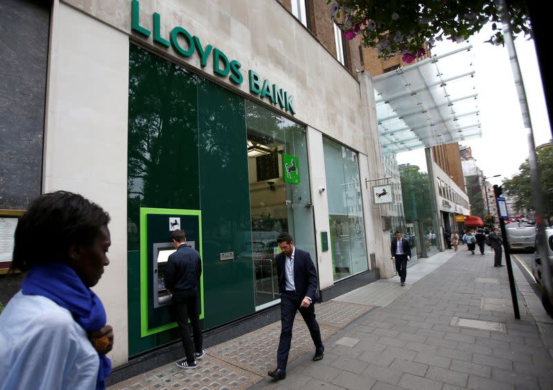 FILE PHOTO: People walk past a branch of Lloyds Bank at Berkeley Square in London