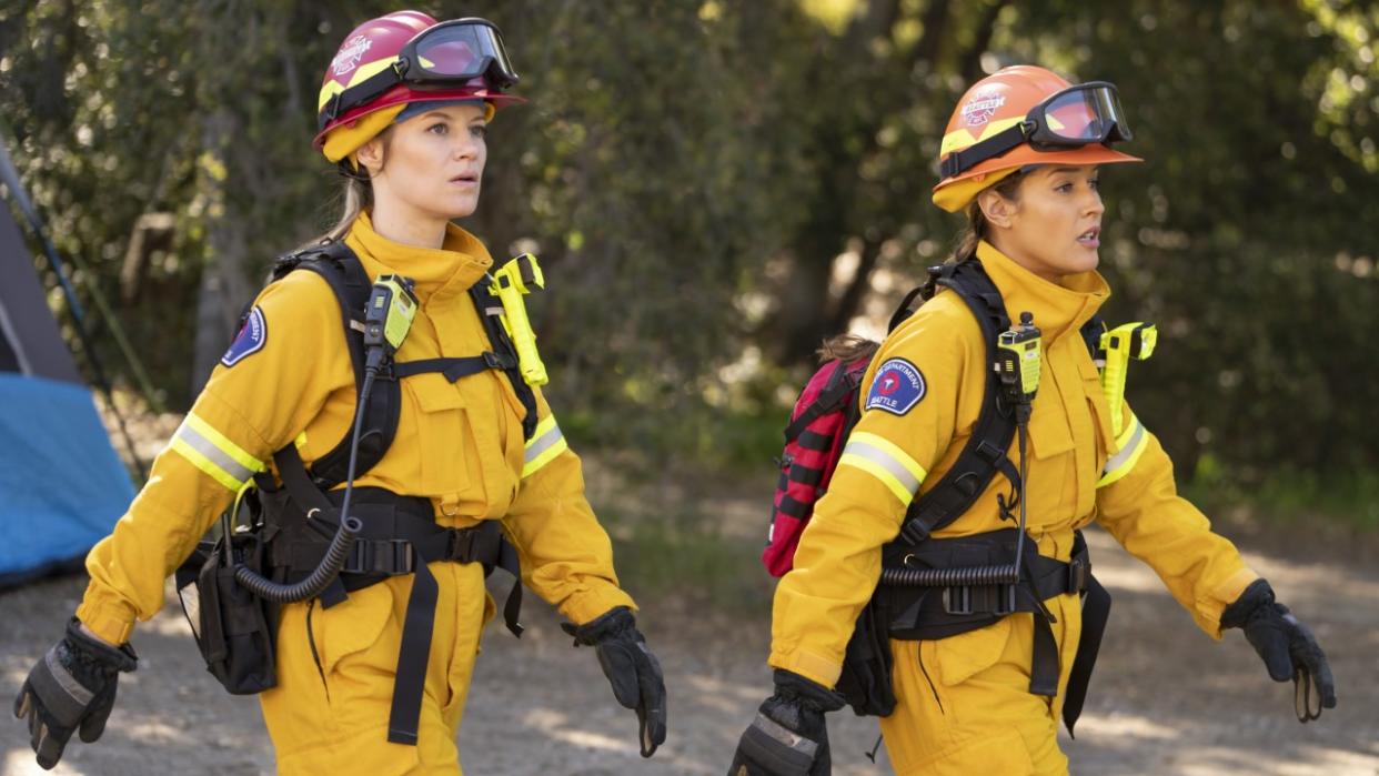  Maya Bishop (Danielle Savre) and Andy Herrera (Jaina Lee Ortiz) walk in the forest during the Station 19 episode "How Am I Supposed to Live Without You.". 