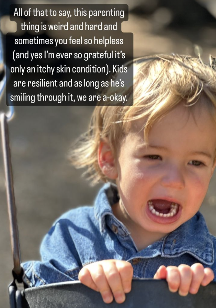 A young boy shouting in a jean shirt in a children's swing at a park.  (Mandy Moore / Instagram)