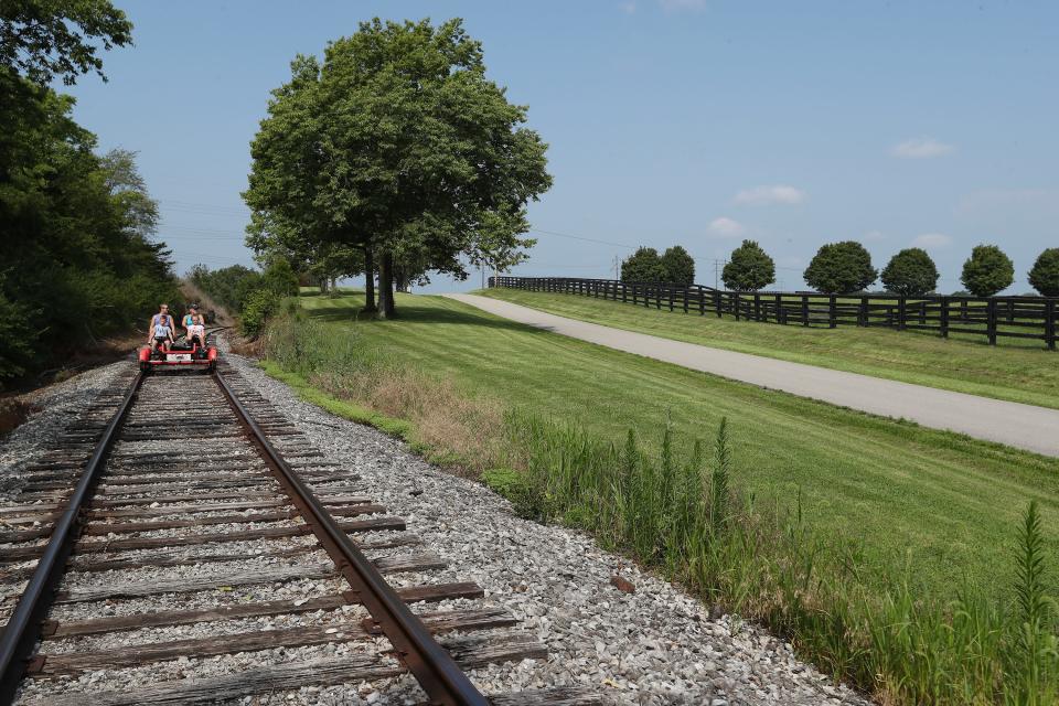 Riders were treated to a 10-mile round-trip scenic view of bourbon distilleries and horse farms aboard Rail Explorers railbikes in Versailles, Ky. on July 27, 2023.  