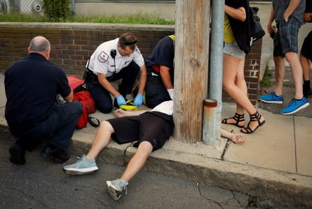 FILE PHOTO: Cataldo Ambulance medics and other first responders revive a man after an opioid overdose on a sidewalk in Everett